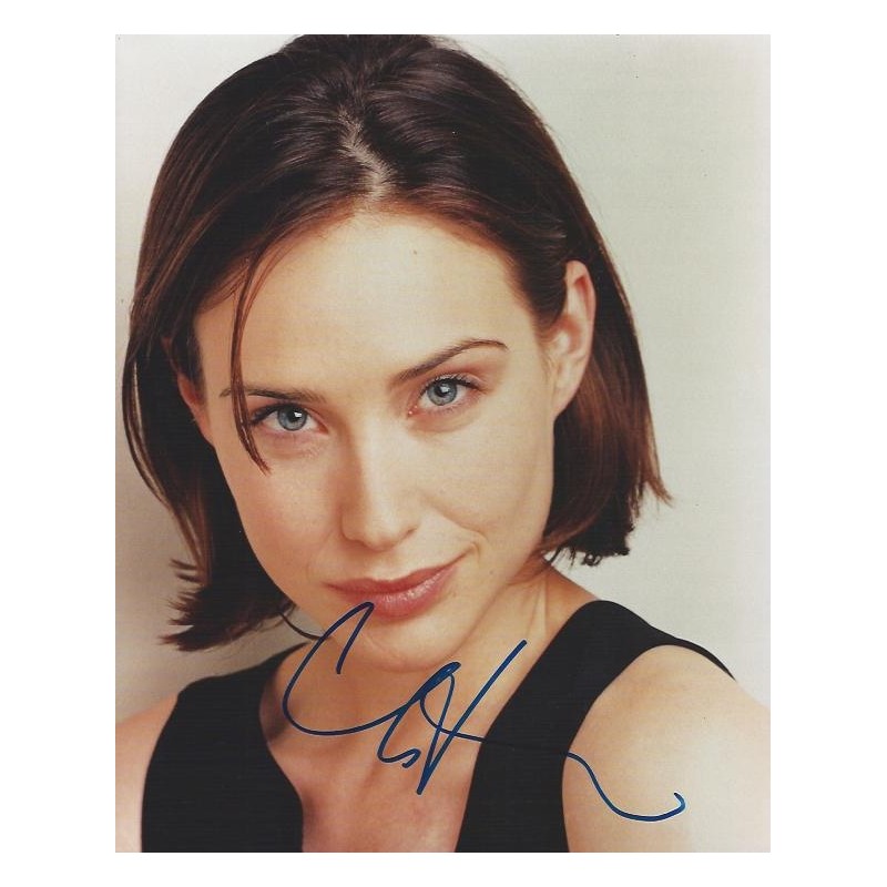 Claire Forlani's free-moving long hair with one side tucked behind